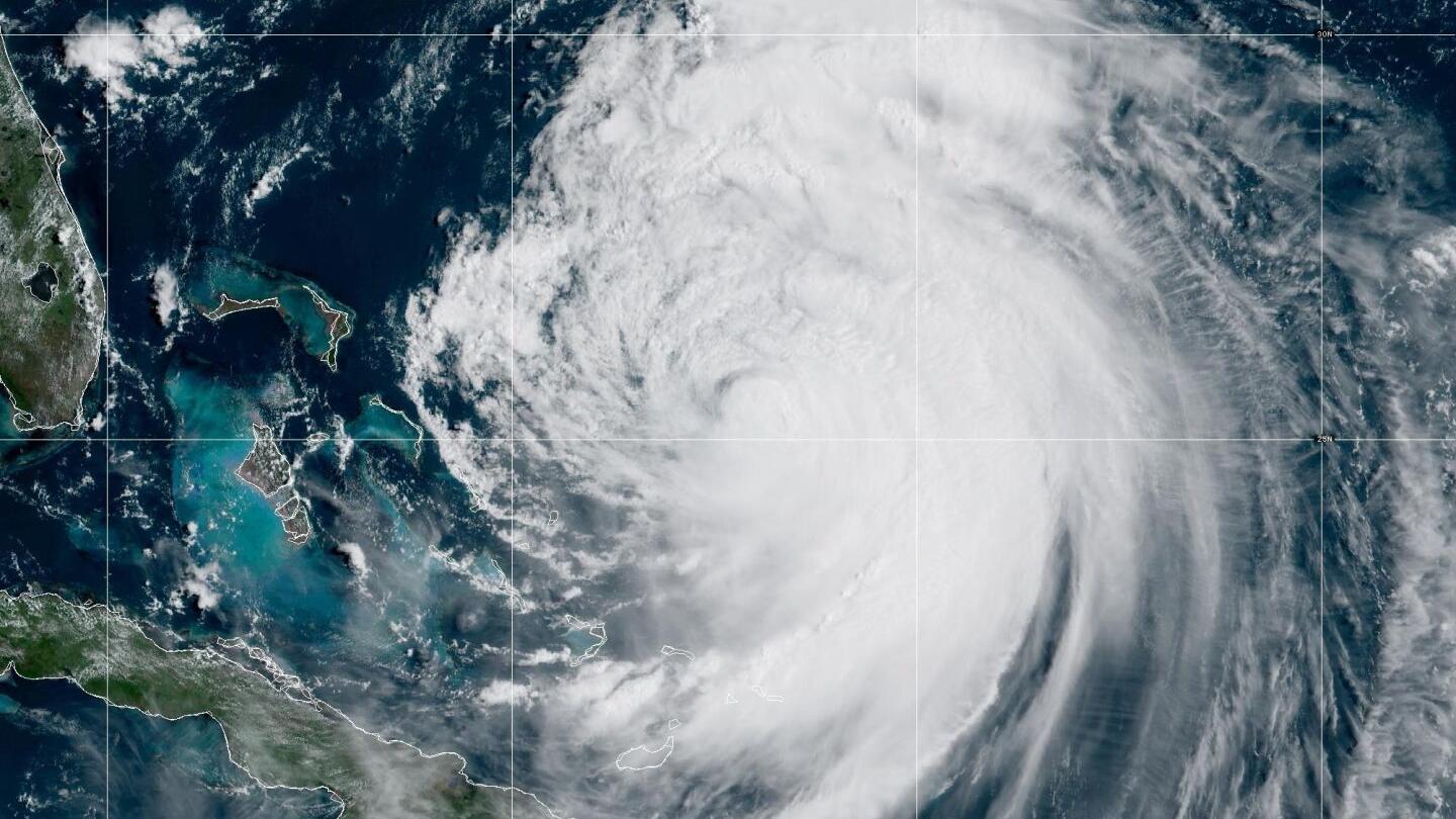 Evacuations in North Carolina as Hurricane Erin grows in size, two waves on its heels